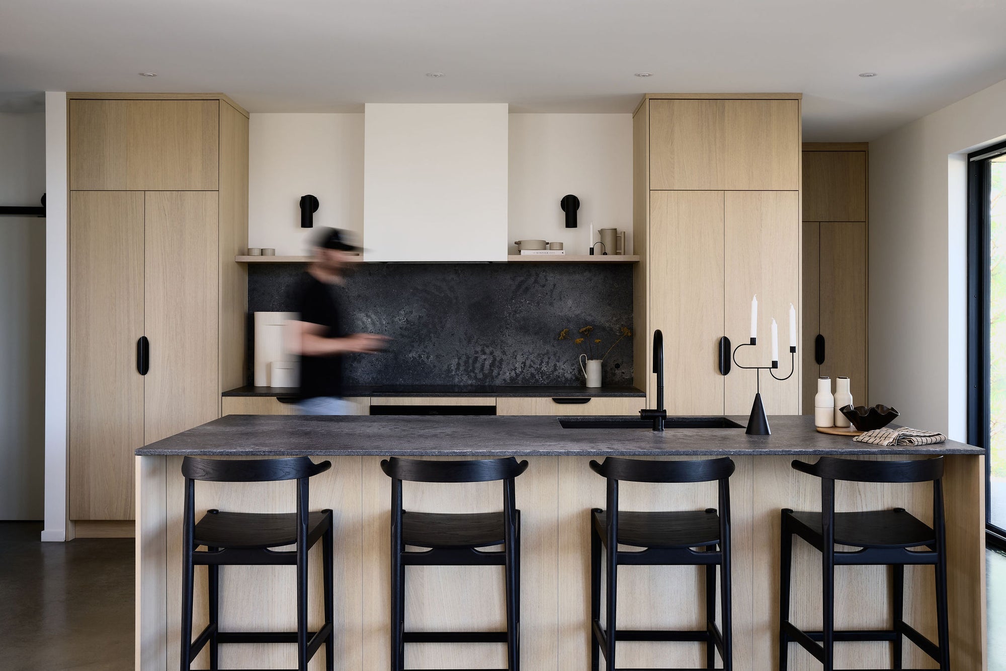 Bright custom kitchen with warm wood cabinetry by Swede
